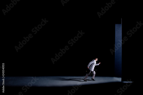 Tableau sur toile man with a briefcase hurries and runs through the open doors, concept business