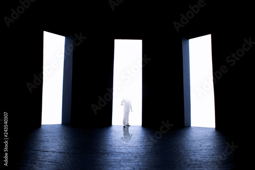 Canvas Print person with a flooded with light face standing inviting by hand to make a choice