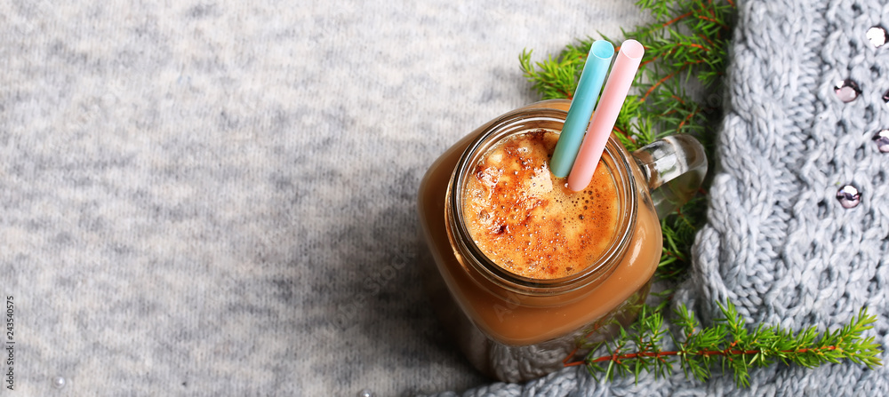 Christmas winter coffee with a spruce branch on a knitted gray background Christmas winter coffee with a spruce branch on a knitted gray background