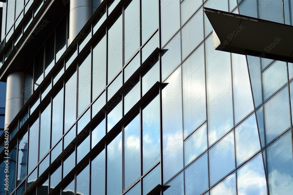 Modern building with reflected sky and cloud in glass window Modern building with reflected sky and cloud in glass window