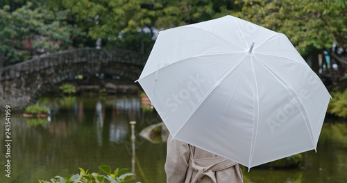 Woman bring umbrella in the park