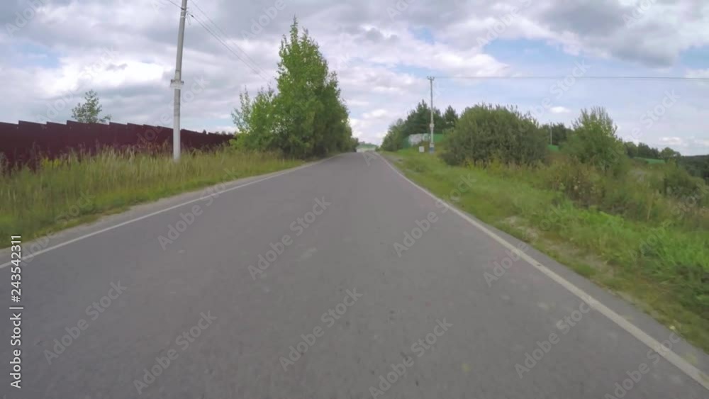 The car moves on a rural road in the summer. Frontal view. The car moves on a rural road in the summer. Frontal view.