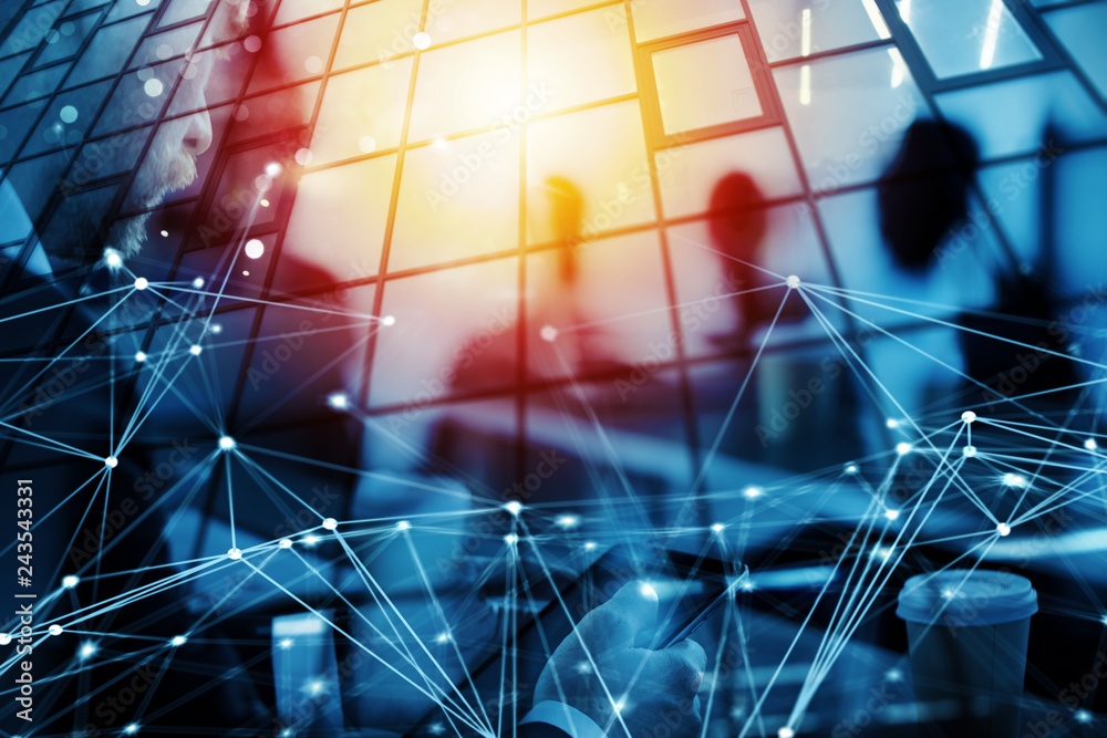 Business man works in office with tablet in the foreground. Concept of teamwork and partnership. double exposure with network effects Business man works in office with tablet in the foreground. Concept of teamwork and partnership. double exposure with network effects