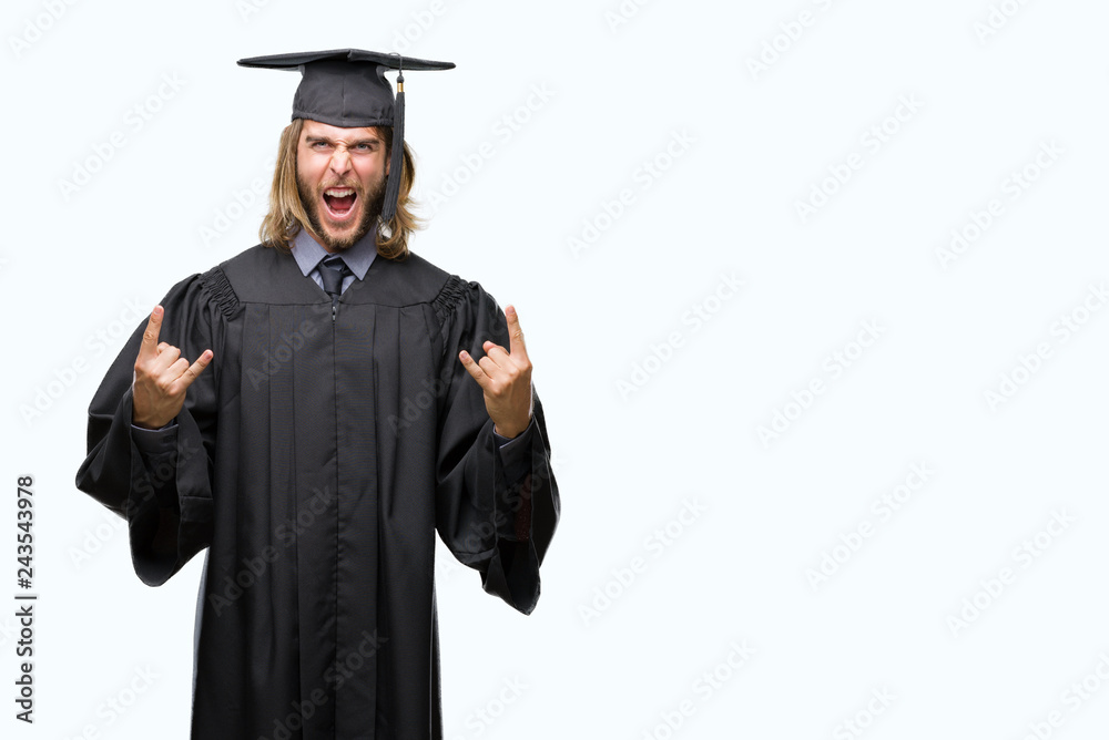 Young handsome graduated man with long hair over isolated background shouting with crazy expression doing rock symbol with hands up. Music star. Heavy concept. Young handsome graduated man with long hair over isolated background shouting with crazy expression doing rock symbol with hands up. Music star. Heavy concept.