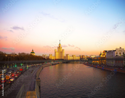 view of the sunset on the river, a residential skyscraper on Kotelnicheskaya Embankment, Moscow River, Bolshoy Ustinsky bridge. Moscow, Russia