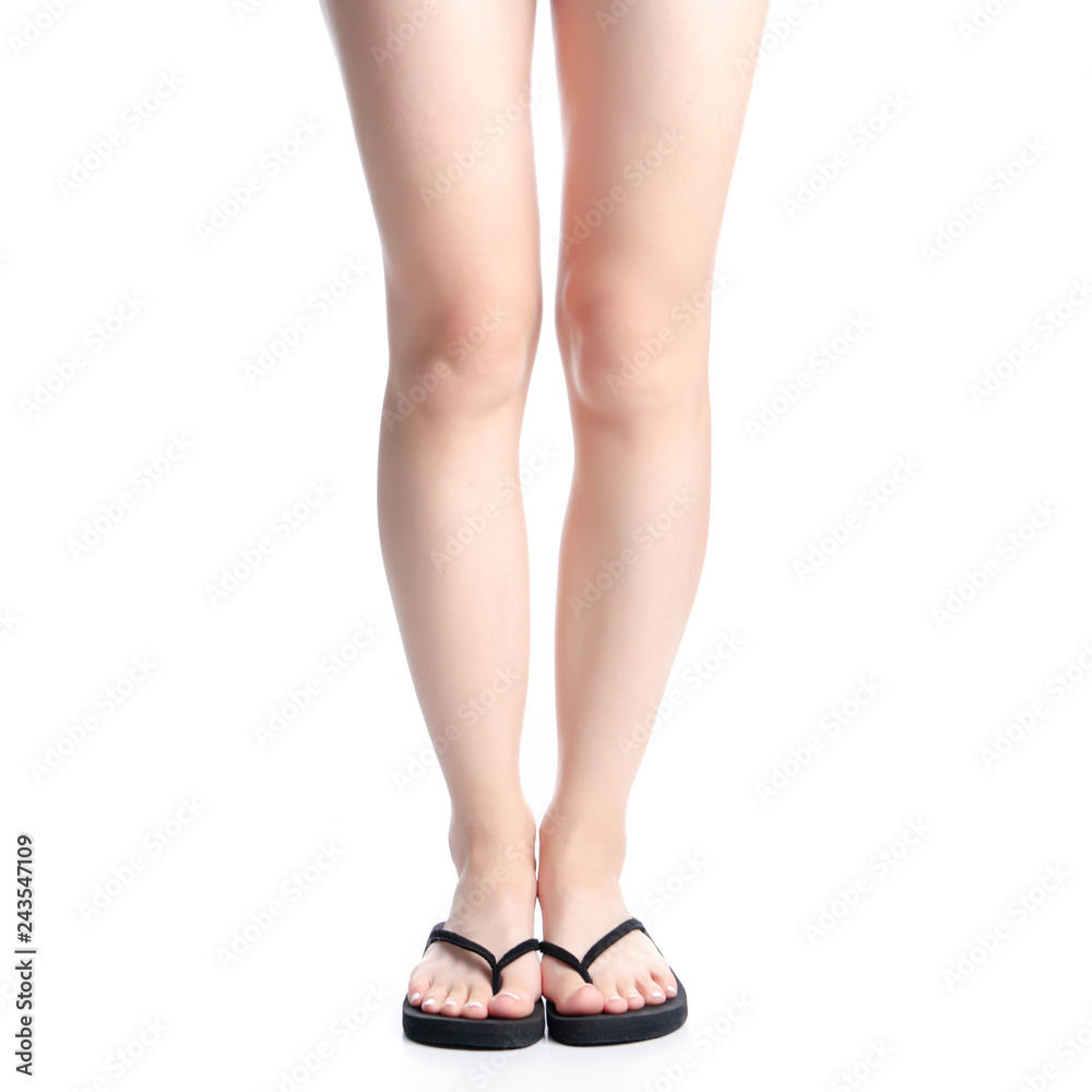Woman legs in black flip flops on white background isolation Woman legs in black flip flops on white background isolation