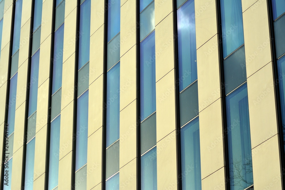 Modern building with reflected sky and cloud in glass window Modern building with reflected sky and cloud in glass window