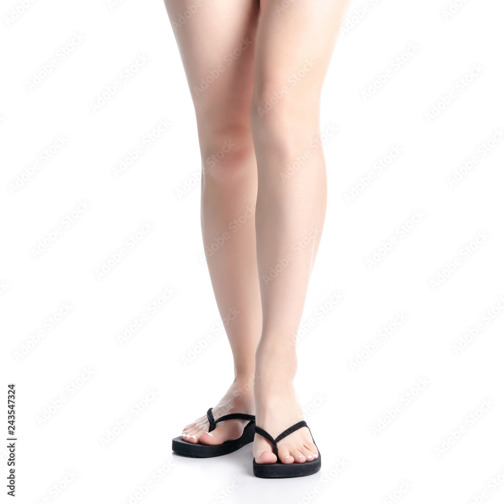 Woman legs in black flip flops on white background isolation Woman legs in black flip flops on white background isolation