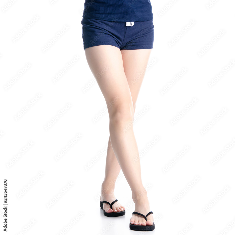 Woman legs in black flip flops on white background isolation Woman legs in black flip flops on white background isolation