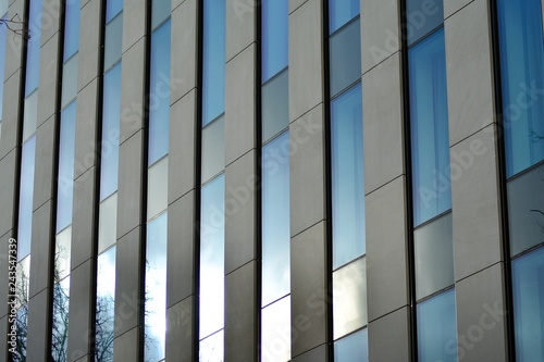 Modern building with reflected sky and cloud in glass window