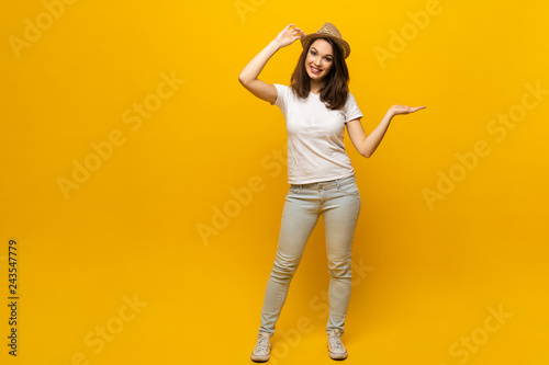 No way, look this ! Woman pointing finger at copy space. Expression emotion and feelings concept. Studio shot, isolated on yellow background.