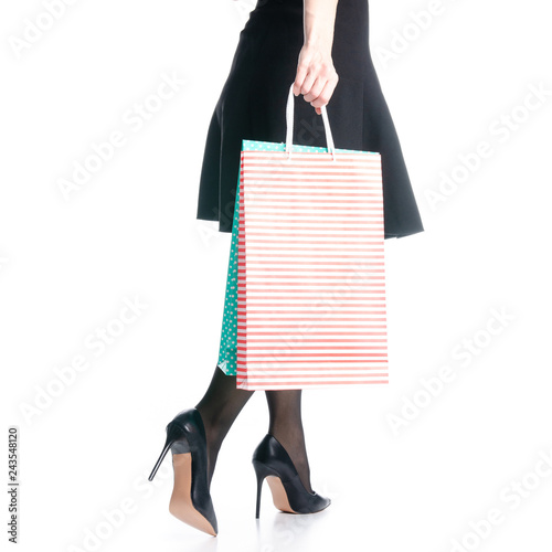 Female legs in black high heels shoes bags package black skirt fashion on white background isolation