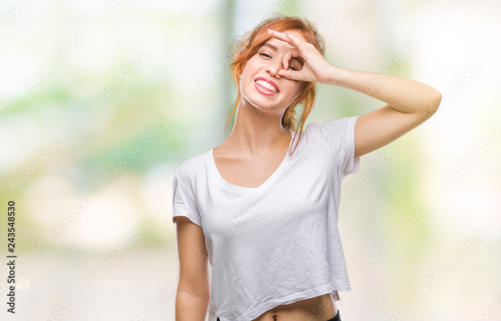 Young beautiful woman over isolated background doing ok gesture with hand smiling, eye looking through fingers with happy face. Young beautiful woman over isolated background doing ok gesture with hand smiling, eye looking through fingers with happy face.