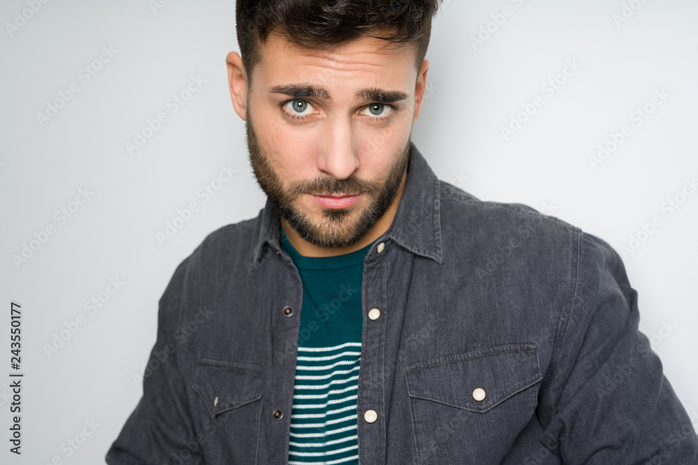 Young handsome man possing and modeling over grey isolated background Young handsome man possing and modeling over grey isolated background