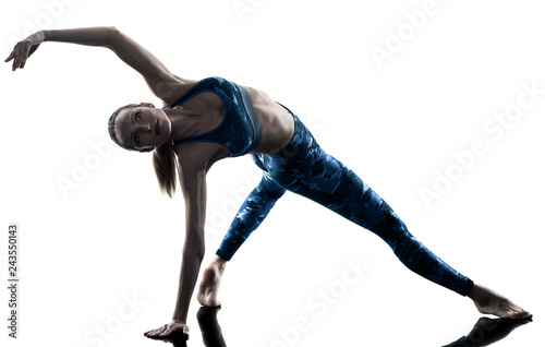 one caucasian woman exercising fitness pilates excercises in silhouette isolated on white background