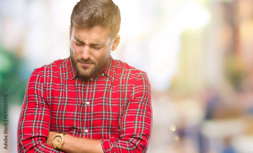 Obraz premium Young handsome man over isolated background with hand on stomach because nausea, painful disease feeling unwell. Ache concept.