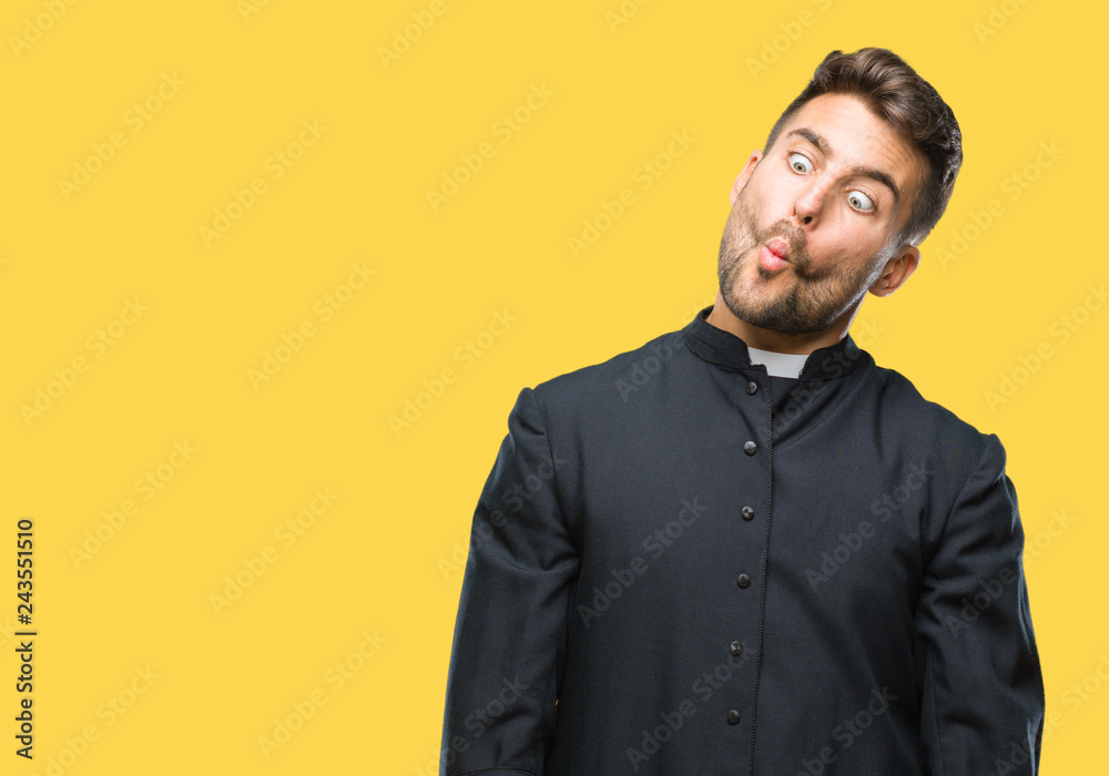 Young catholic christian priest man over isolated background making fish face with lips, crazy and comical gesture. Funny expression. Young catholic christian priest man over isolated background making fish face with lips, crazy and comical gesture. Funny expression.