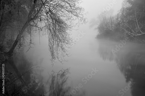 Romantic foggy river at dawn