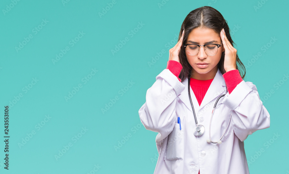 Young arab doctor woman over isolated background with hand on head for pain in head because stress. Suffering migraine. Young arab doctor woman over isolated background with hand on head for pain in head because stress. Suffering migraine.
