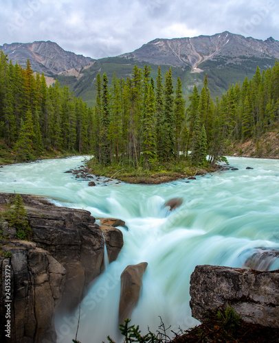 Sunwapta Falls with blue water flowing in Spring, Alberta, Canada.
