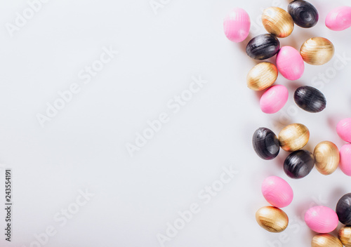 Black and gold eggs over white background.