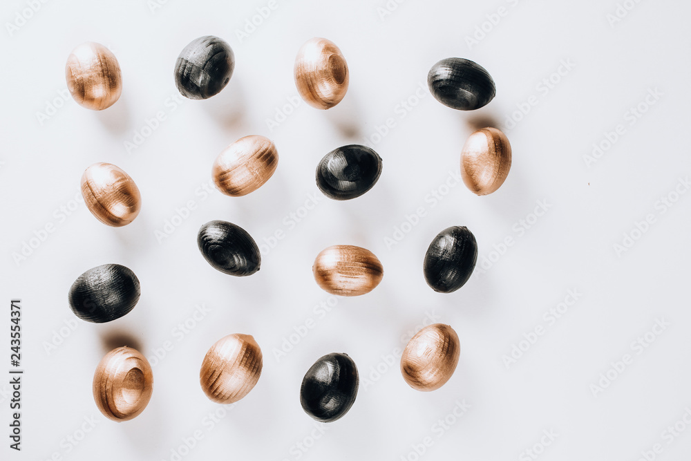 Black and gold eggs over white background. Black and gold eggs over white background.