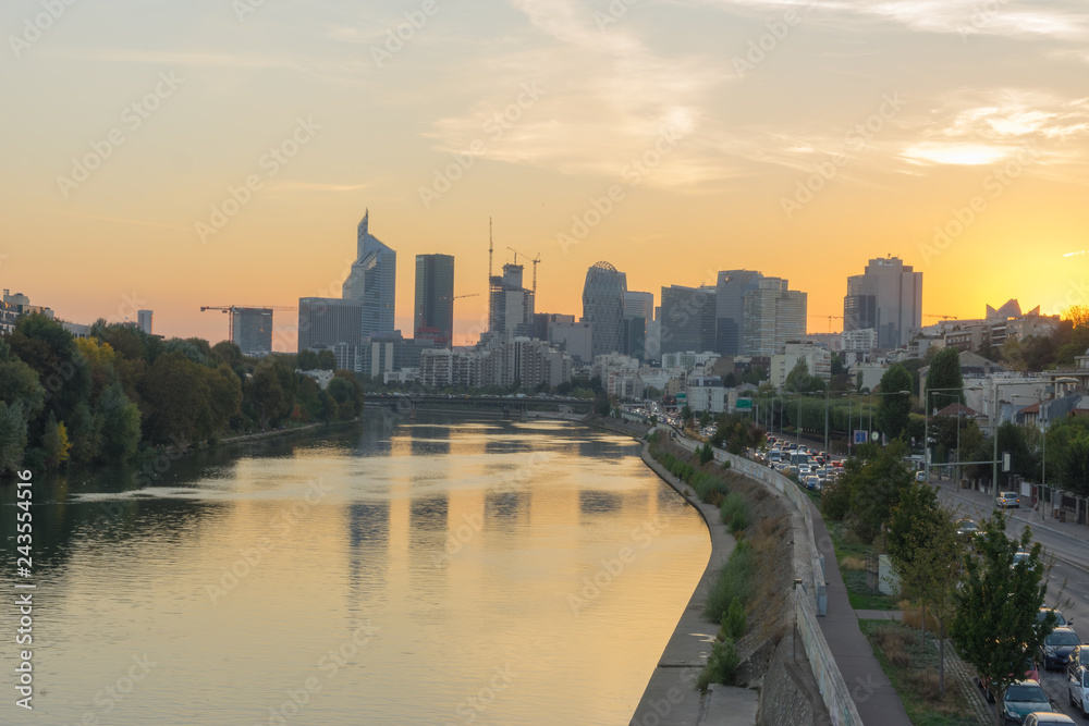 Fototapeta premium Paris, France - 10 15 2018: View of the towers of La Défense district from the Levallois bridge at sunrise