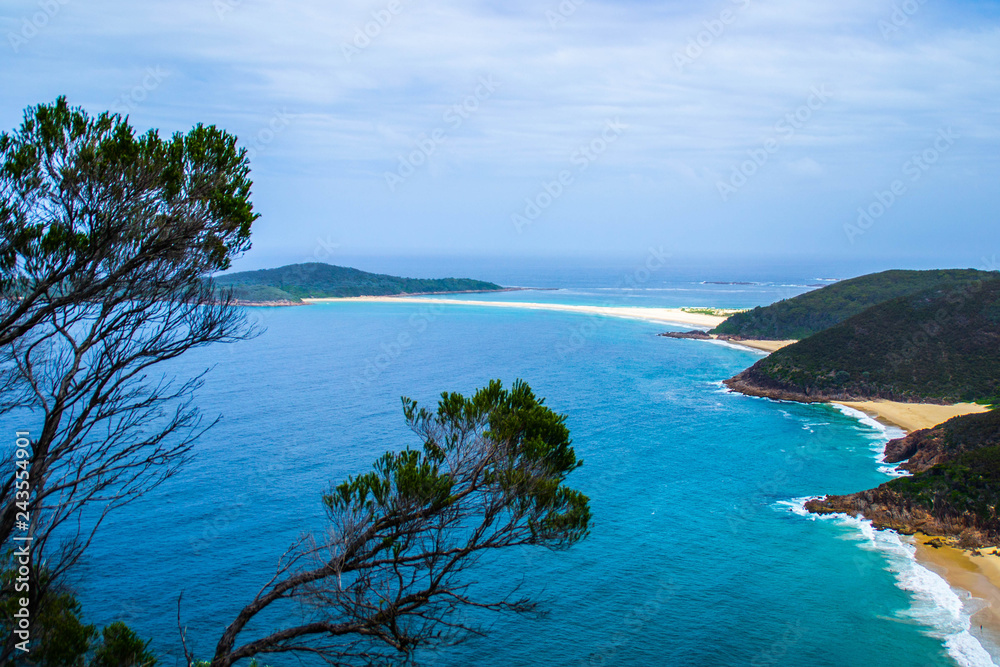 Panoramic landscape view of Zenith Beach and turquoise ocean water from the peak of Tomaree mountain(head) lookout. Shoal Bay, Port Stephens in New South Wales, Australia