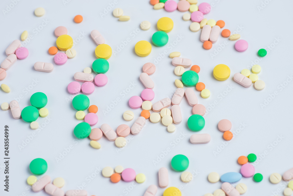 Green and yellow pills or capsules on a white background Green and yellow pills or capsules on a white background