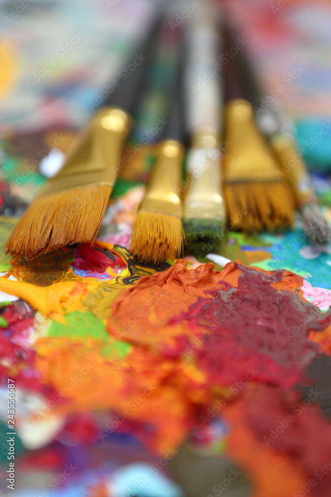 Fototapeta premium workplace painter palette with colors and brushes. Palette of colors, creative disorder, art.