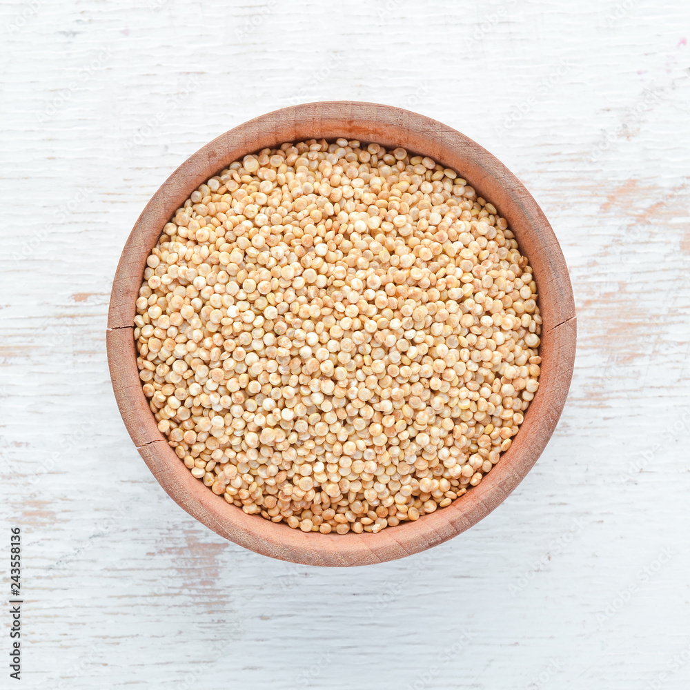 White quinoa On a white wooden background. Top view. Free copy space. White quinoa On a white wooden background. Top view. Free copy space.