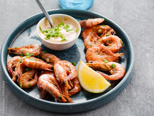 Shrimp glazed in soy sauce with green onion and lemon.