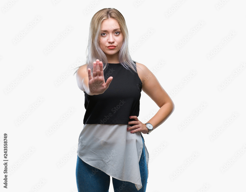 Young blonde woman over isolated background doing stop sing with palm of the hand. Warning expression with negative and serious gesture on the face. Young blonde woman over isolated background doing stop sing with palm of the hand. Warning expression with negative and serious gesture on the face.