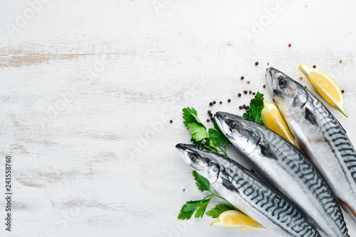 Mackerel on a white wooden background. Raw fish Top view. Free copy space.