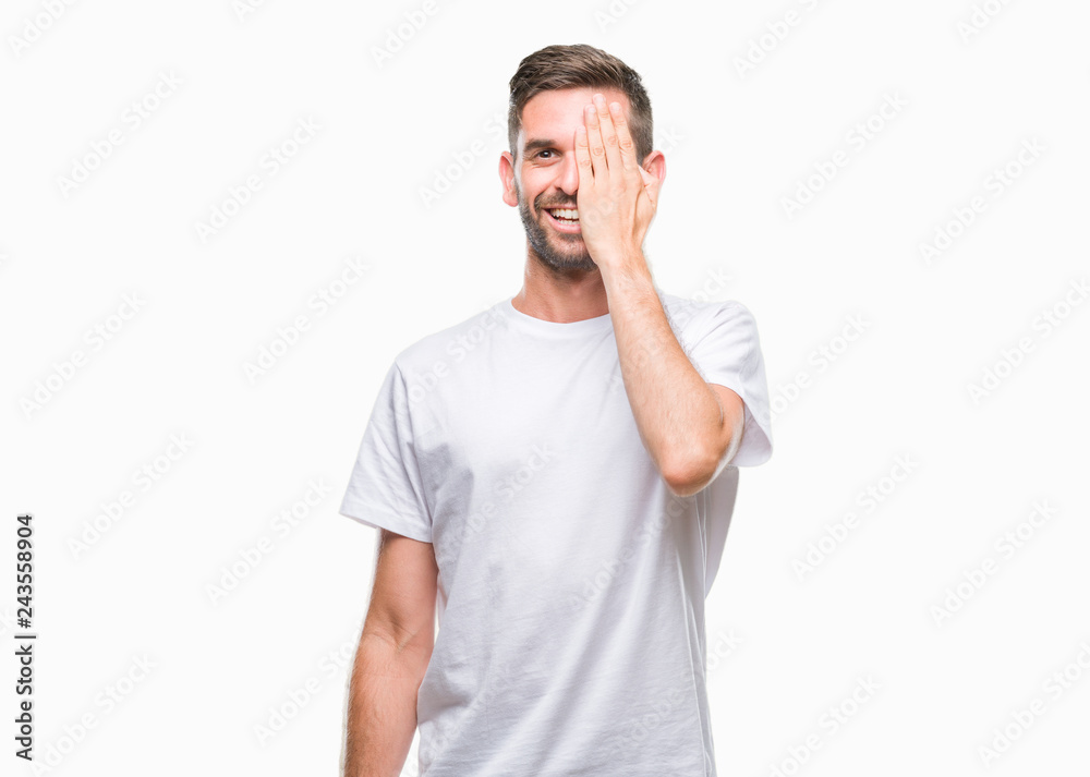 Young handsome man over isolated background covering one eye with hand with confident smile on face and surprise emotion. Young handsome man over isolated background covering one eye with hand with confident smile on face and surprise emotion.