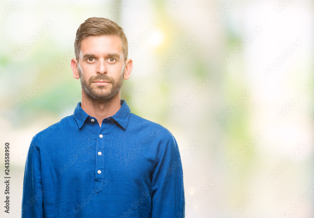 Young handsome man over isolated background with serious expression on face. Simple and natural looking at the camera. Young handsome man over isolated background with serious expression on face. Simple and natural looking at the camera.