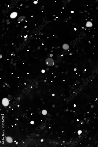 Snow on black background. Falling snow texture.
