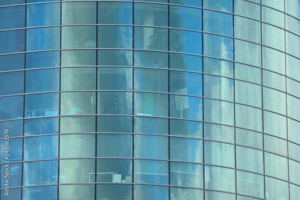 Modern building with reflected sky and cloud in glass window Modern building with reflected sky and cloud in glass window