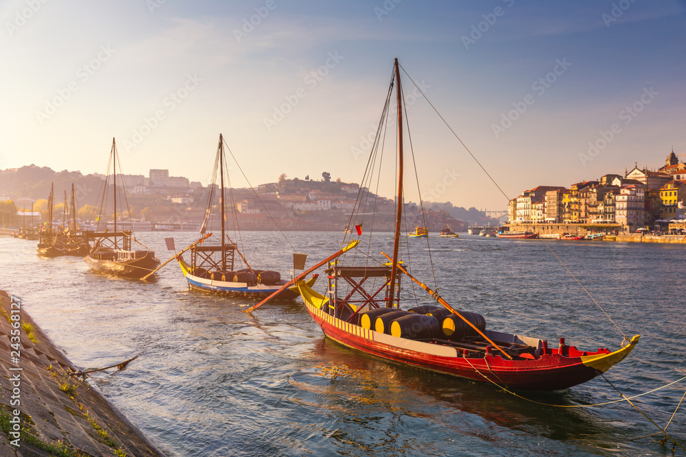 Port wine boats at the waterfront with the old town on the Douro River in Ribeira in the city centre of Porto in Porugal, Europe. Portugal, Porto
