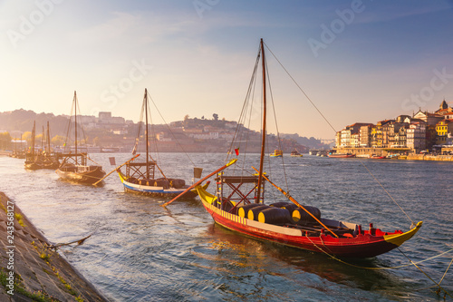 Port wine boats at the waterfront with the old town on the Douro River in Ribeira in the city centre of Porto in Porugal, Europe. Portugal, Porto