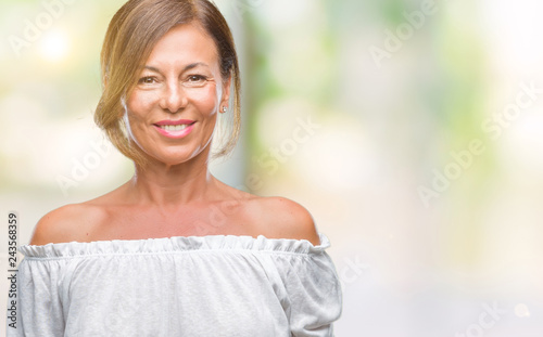 Middle age senior hispanic woman over isolated background with a happy and cool smile on face. Lucky person.