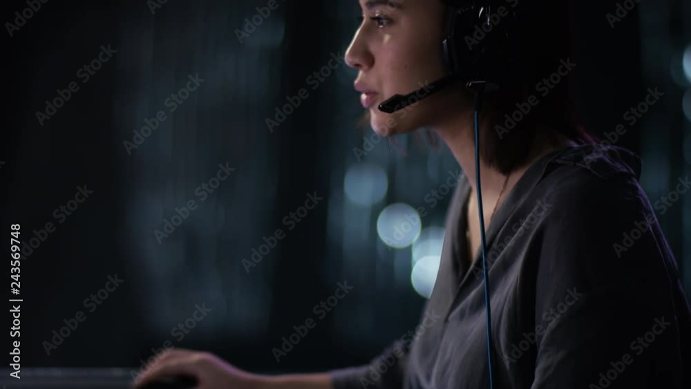 dark haired woman talking over headset with vertical camera movement dark haired woman talking over headset with vertical camera movement
