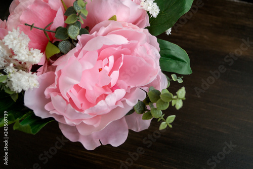 Fototapeta Naklejka Na Ścianę i Meble -  Pink artificial peonies on a black background.