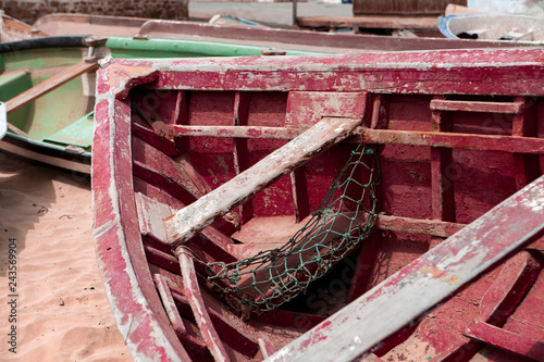 Old fishing boat on the shore. Boat with nets waiting for fishermen on the beach of Cape Verde.