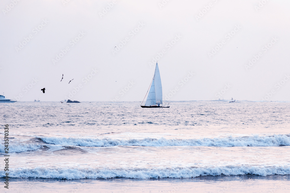 Sailboat in the sea, luxury summer adventure. Sailing in the wind through the waves at the sea. Travel and active lifestyle concept. Summer vacation background