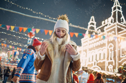 A young woman walks around the New Year Fair © primipil