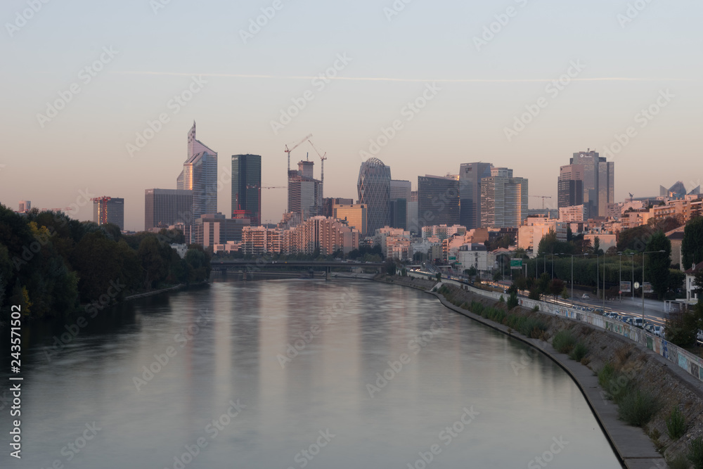 Paris, France - 10 16 2018: View of the towers of La Défense district from the Levallois bridge at sunrise