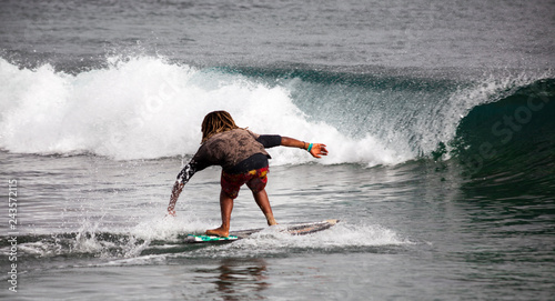 Surfing. A young man slides on a Board on the waves of the ocean. Cape Verde