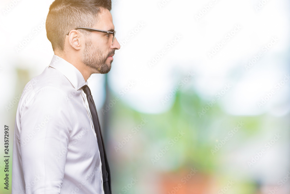 Young handsome business man wearing glasses over isolated background looking to side, relax profile pose with natural face with confident smile. Young handsome business man wearing glasses over isolated background looking to side, relax profile pose with natural face with confident smile.
