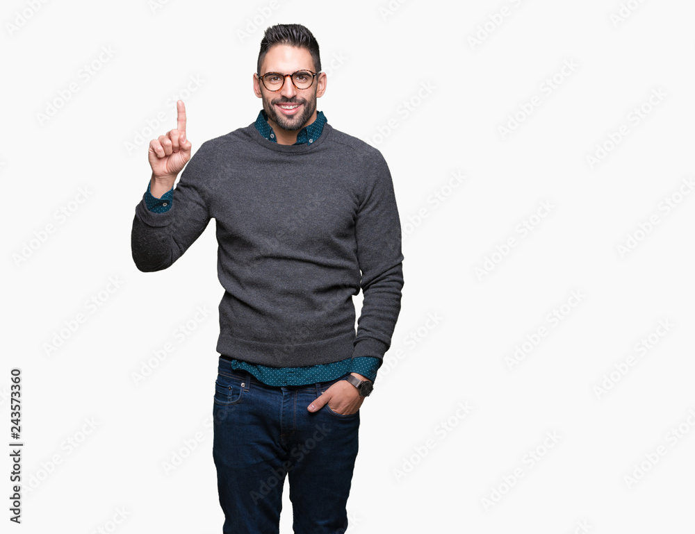 Young handsome man wearing glasses over isolated background showing and pointing up with finger number one while smiling confident and happy. Young handsome man wearing glasses over isolated background showing and pointing up with finger number one while smiling confident and happy.